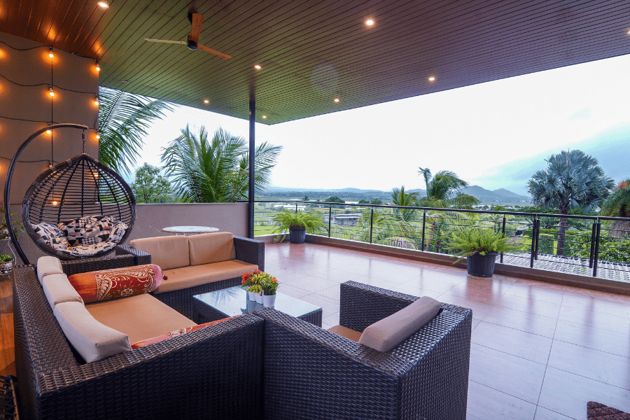 Luxury villa Nashik balcony with garden view and cozy seating for relaxing evenings