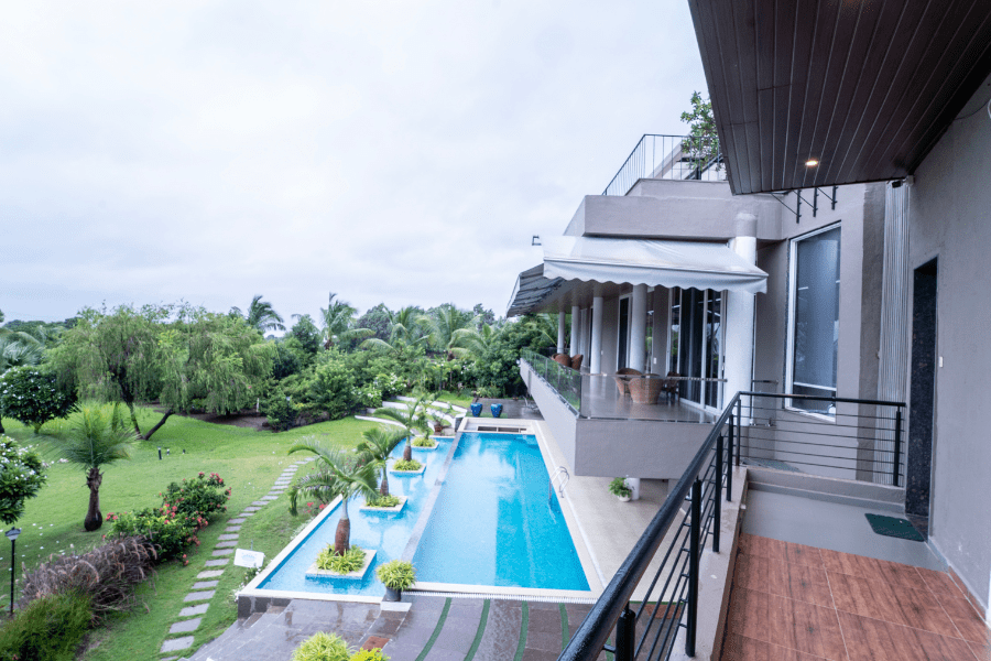 Luxury villa in Nashik with private pool, garden view, and modern outdoor seating.