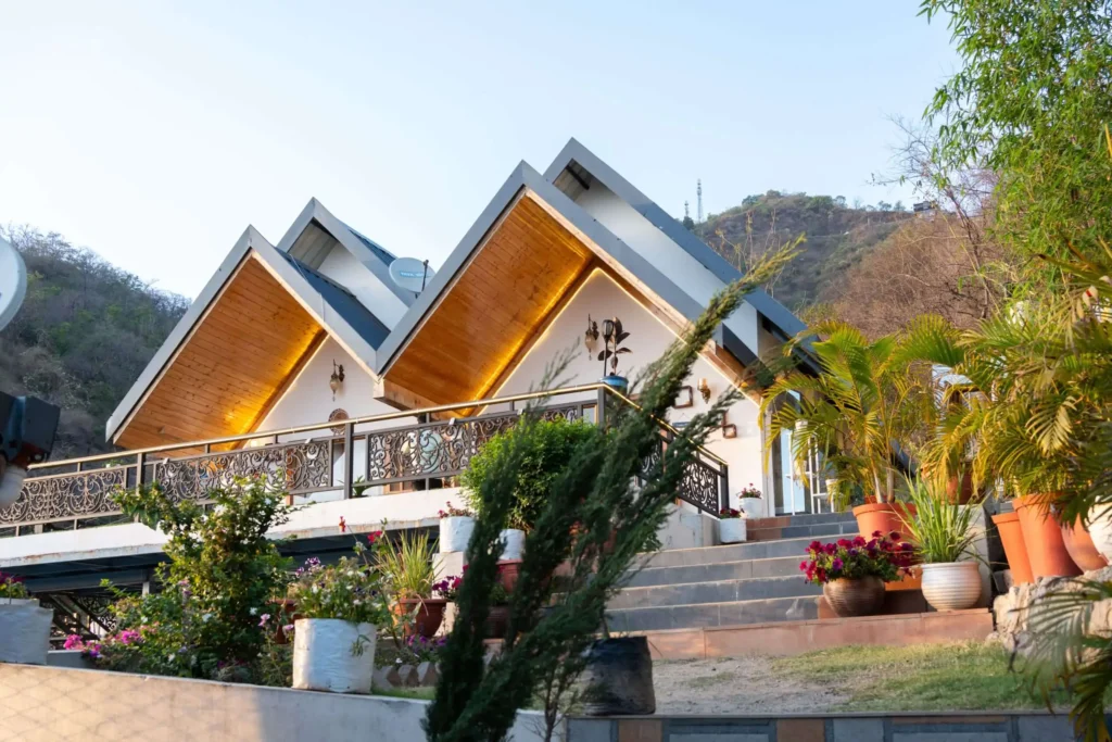Best villa in Dehradun featuring modern architecture, lush green surroundings, and an elevated outdoor space with scenic mountain views for a perfect getaway.