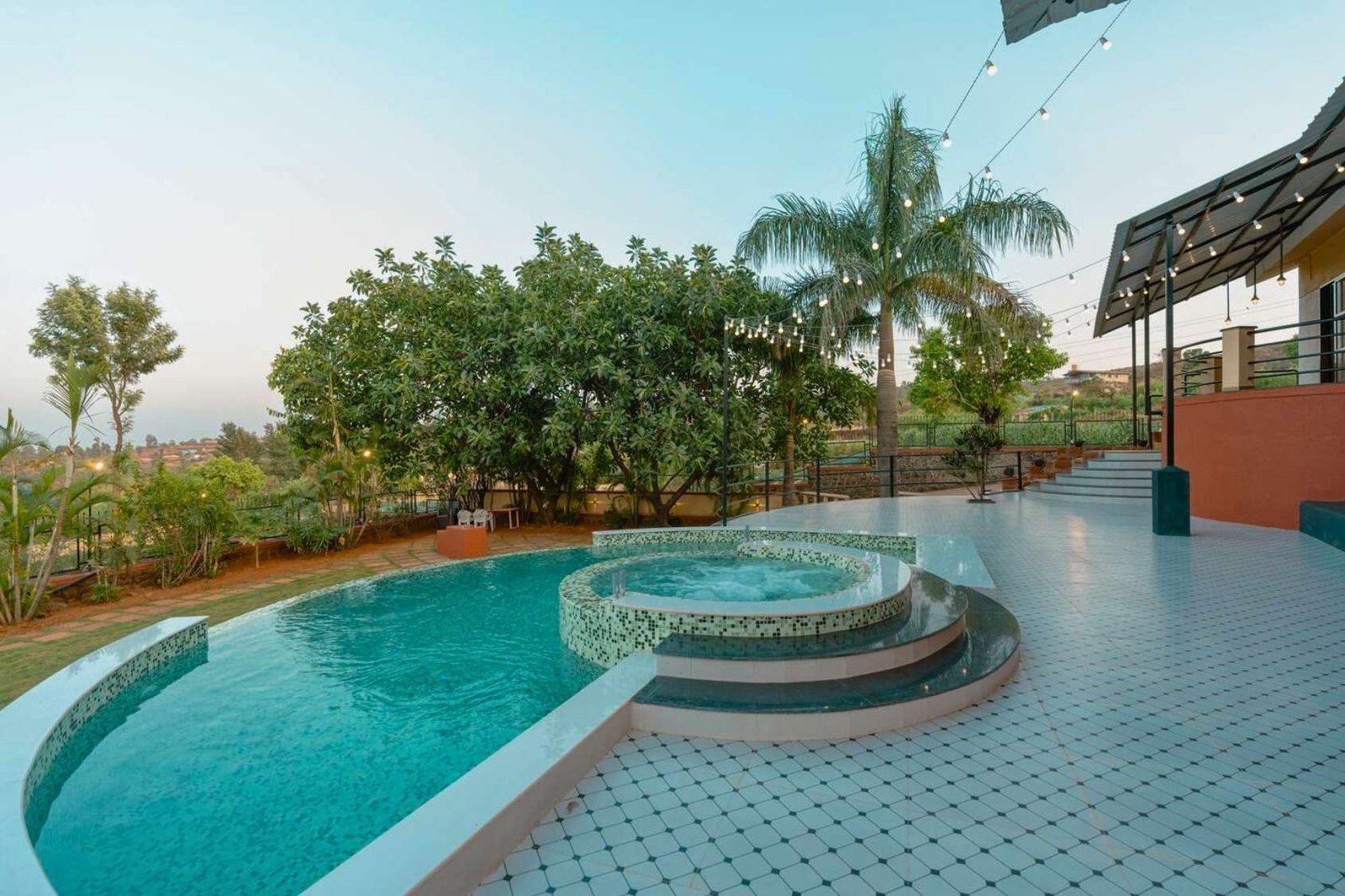 Private pool villa in Panchgani with large pool and relaxing deck, surrounded by nature.