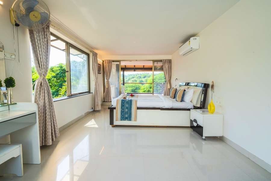 Balcony lounge overlooking lush landscape, part of a Luxury Villa Stay in Nashik.