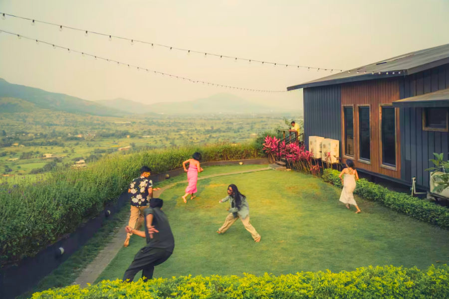 Friends enjoying a digital detox night at a villa with board games and laughter.