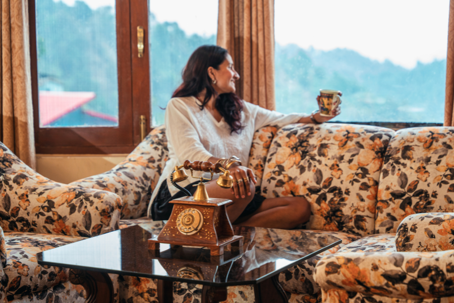 Traveler enjoying a slow morning at a villa surrounded by nature.